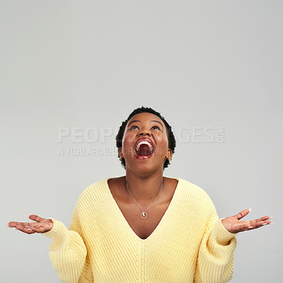 Buy stock photo Shot of a young woman holding up her hands while standing against a grey background