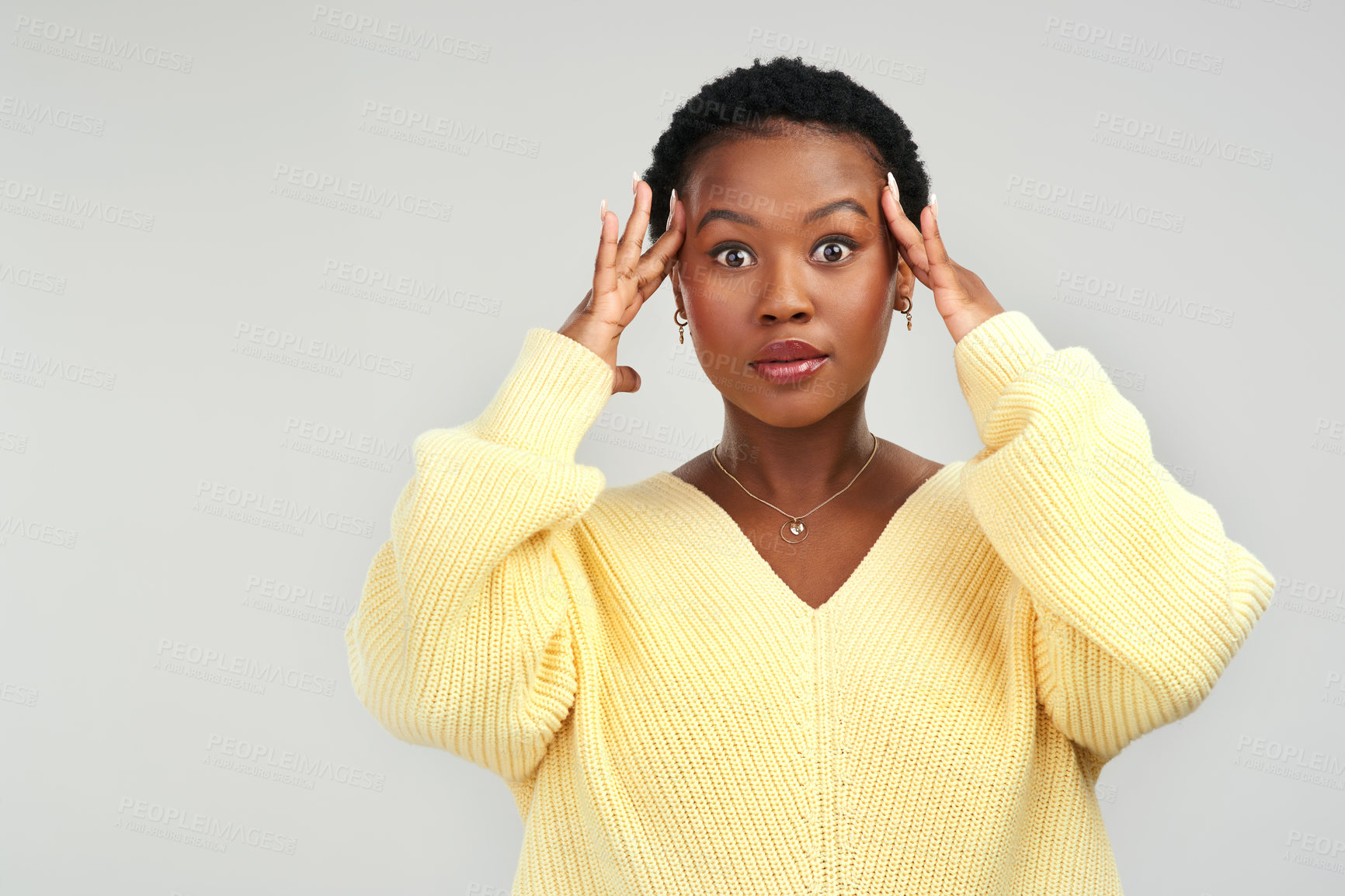 Buy stock photo Shot of a young woman looking stressed while posing against a grey background