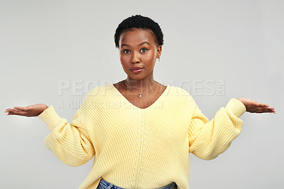 Buy stock photo Shot of a young woman holding up her hands while standing against a grey background