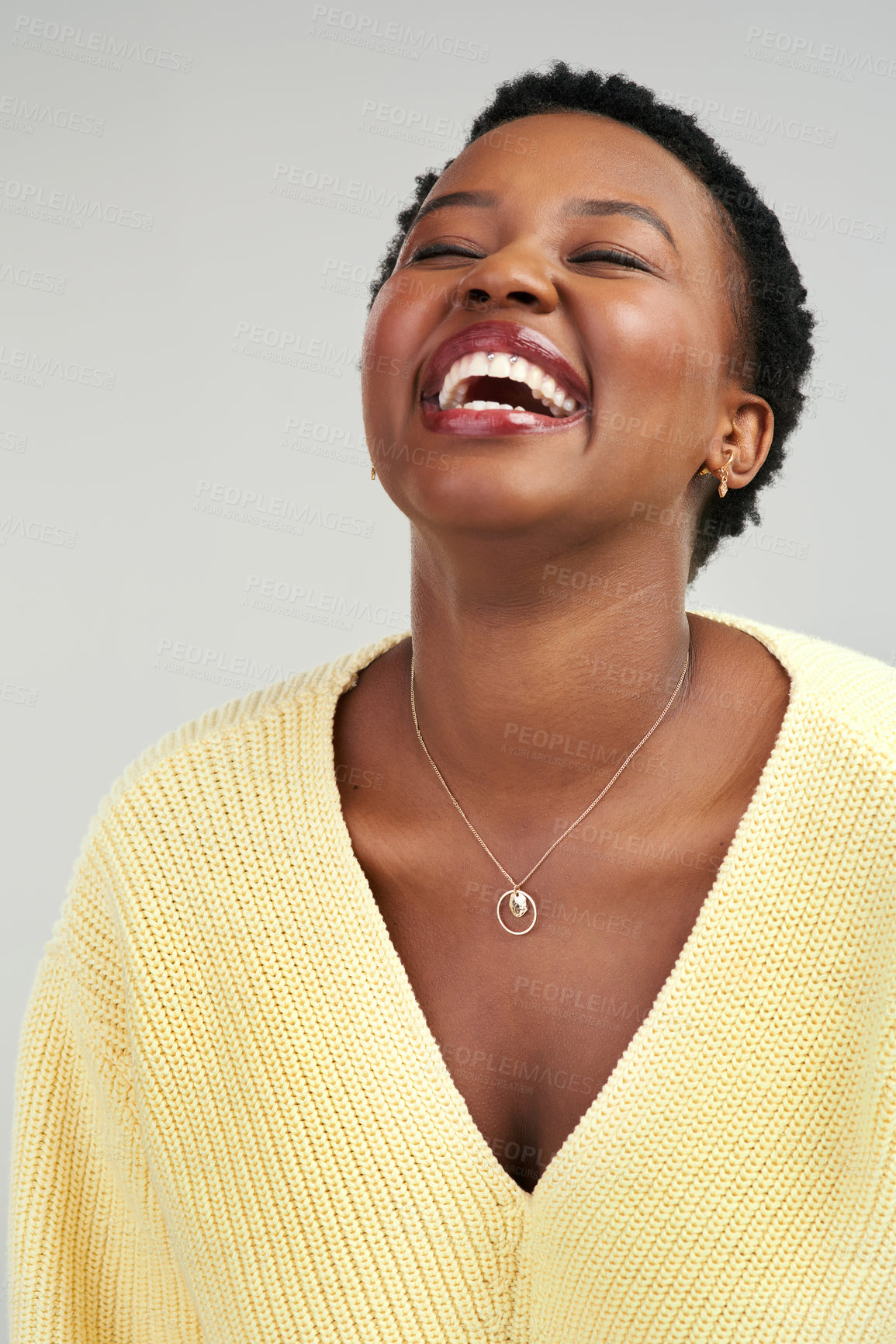 Buy stock photo Closeup shot of a beautiful young woman standing against a grey background