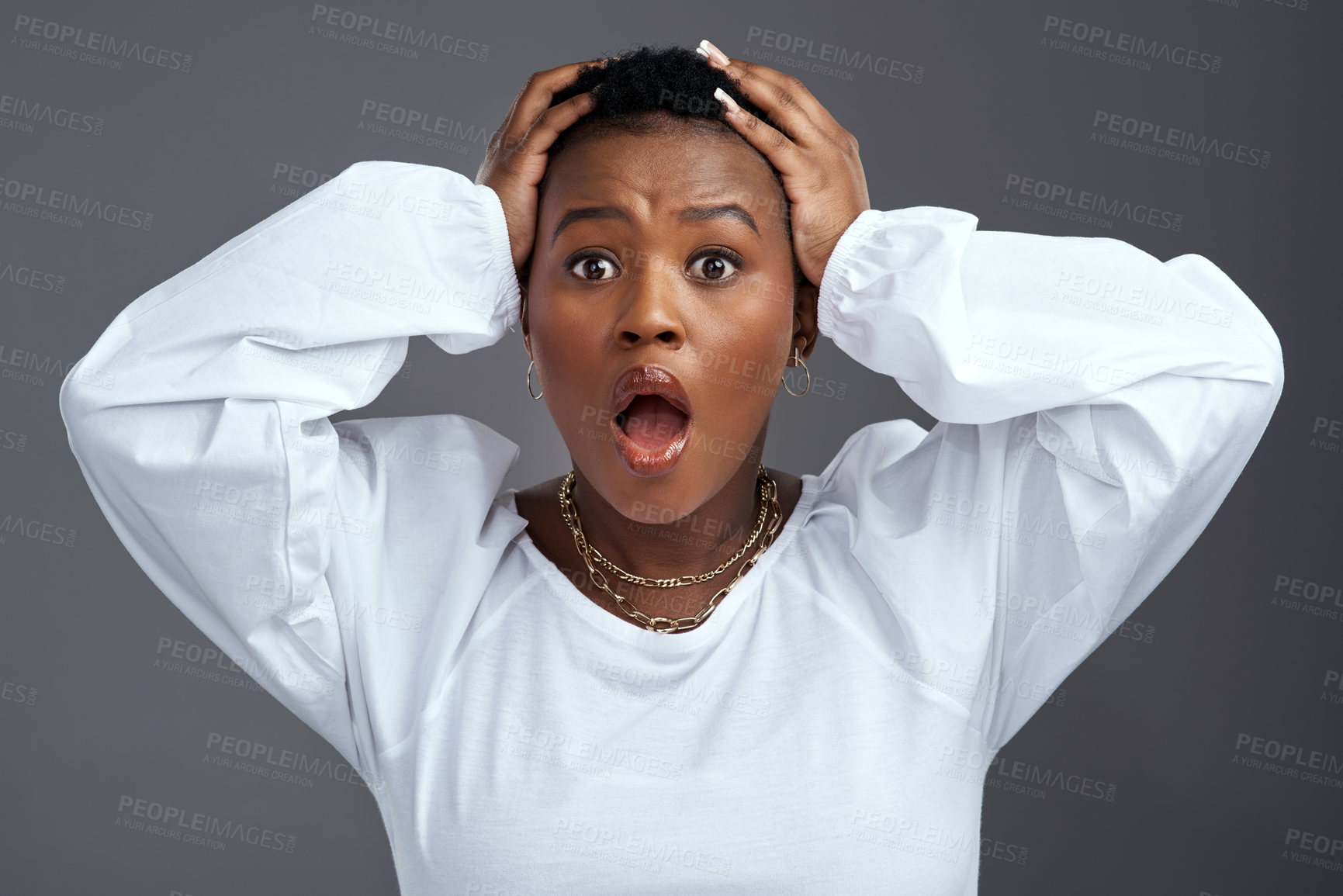 Buy stock photo Shot of a woman looking worried while standing against a grey background