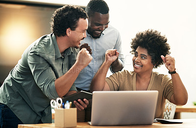 Buy stock photo Shot of a young group of businesspeople celebrating an achievement together while using a laptop