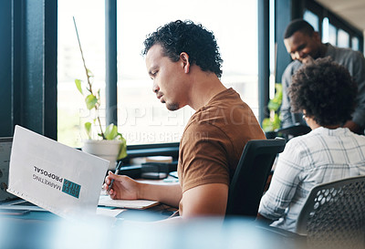 Buy stock photo Shot of a young businessman working in an office