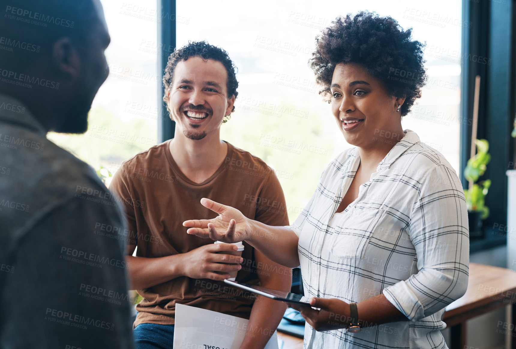 Buy stock photo Shot of a group of young businesspeople talking in an office