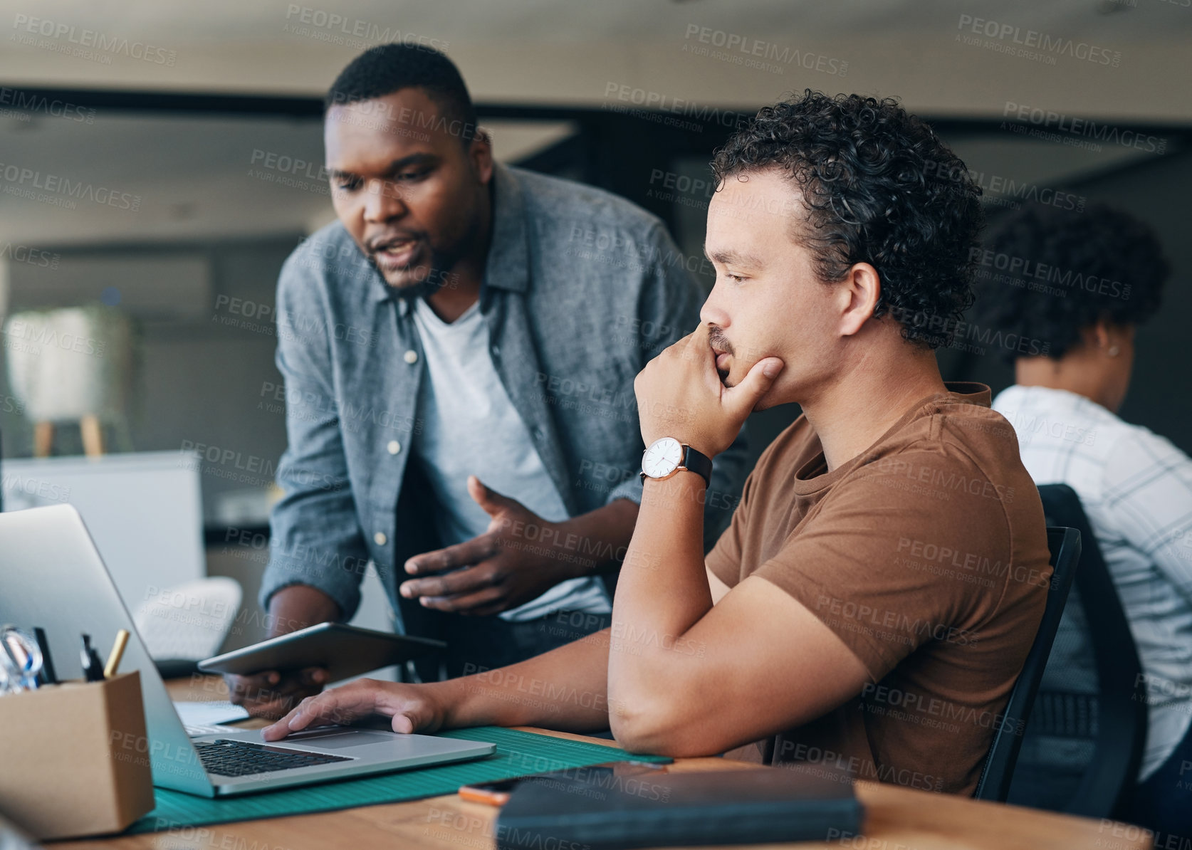 Buy stock photo Shot of two young businessmen working together in an office