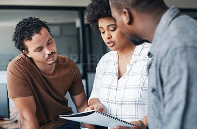 Buy stock photo Shot of a group of young businesspeople talking in an office