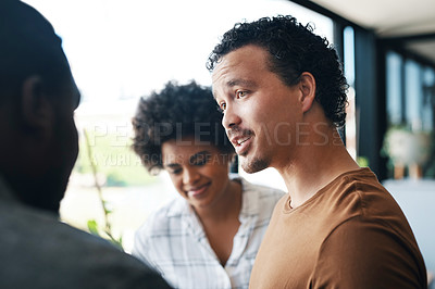 Buy stock photo Shot of a group of young businesspeople talking in an office