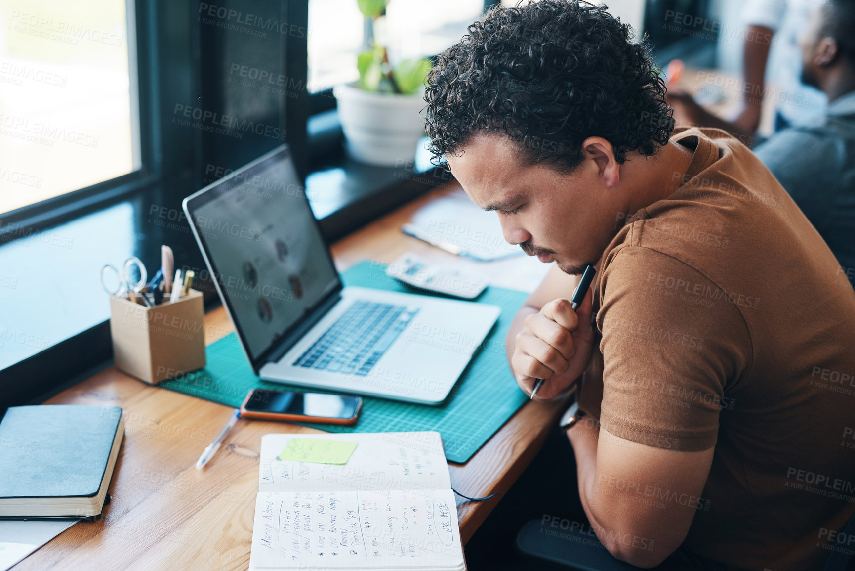 Buy stock photo Shot of a young businessman working in an office