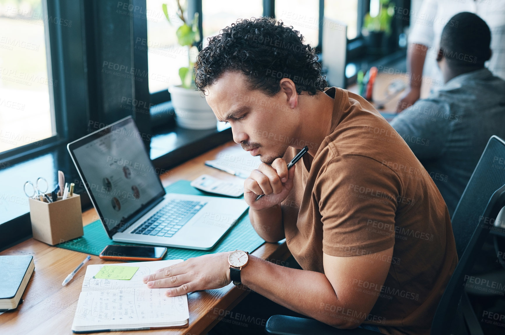 Buy stock photo Shot of a young businessman working in an office