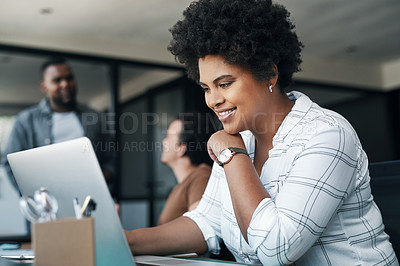 Buy stock photo Shot of a young woman using a laptop in an office