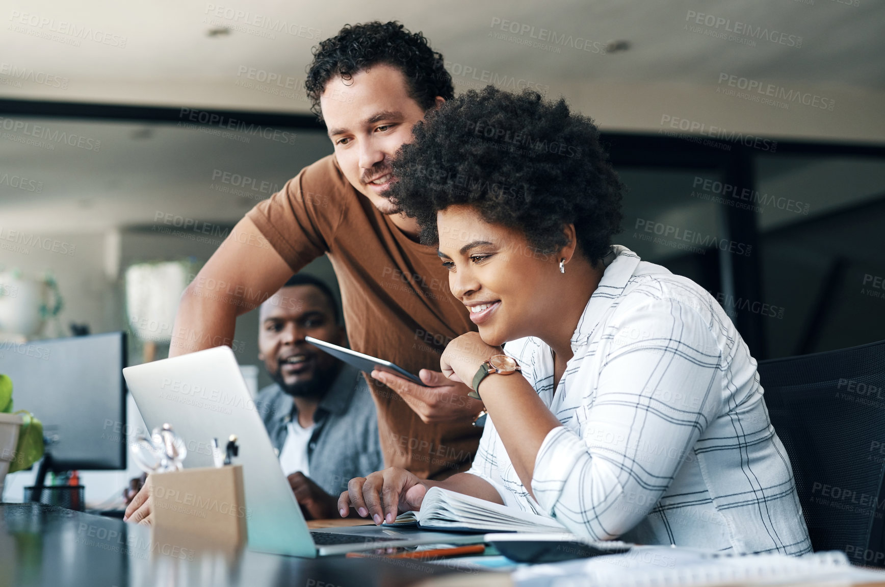 Buy stock photo Shot of two young businesspeople working together in an office