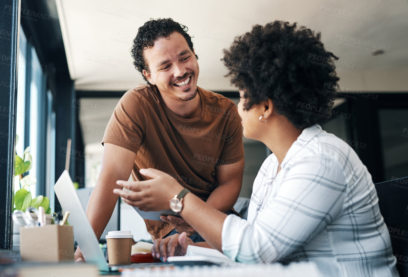 Buy stock photo Shot of two young businesspeople working together in an office