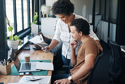 Buy stock photo Shot of two young businesspeople working together in an office