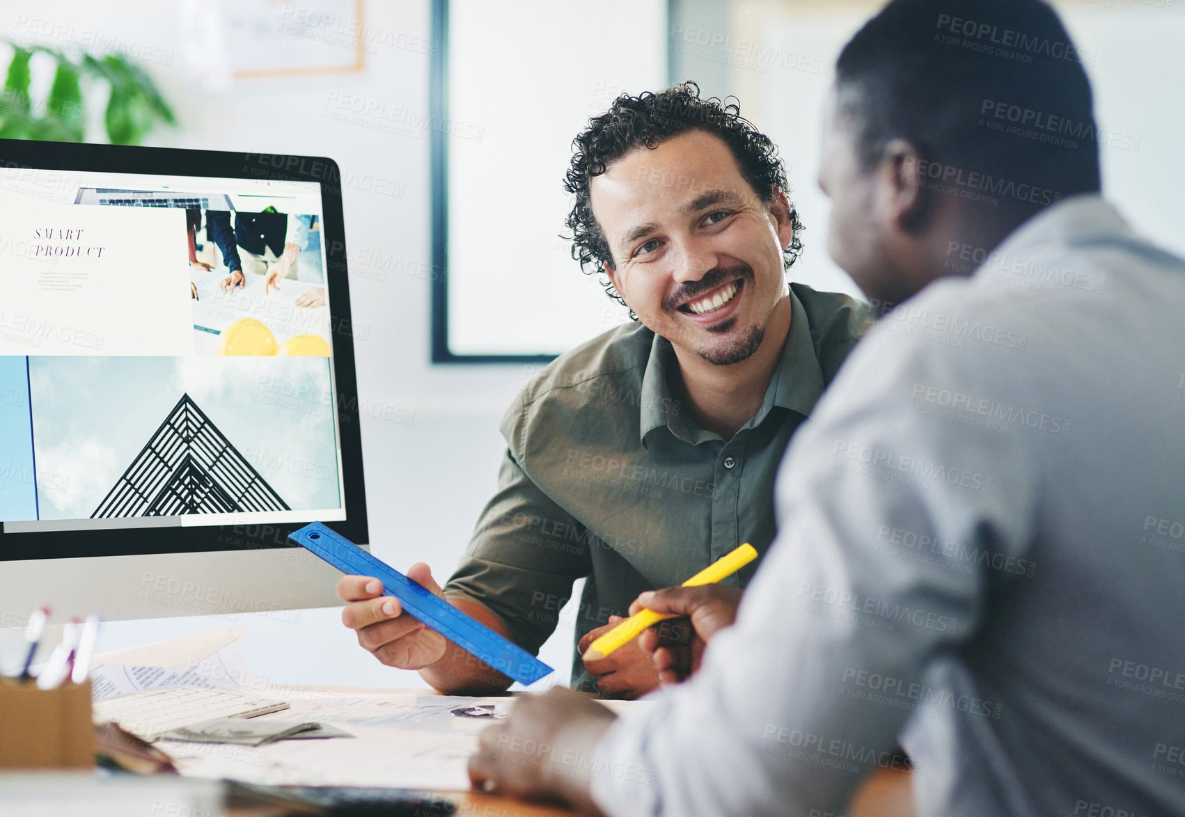 Buy stock photo Shot of two young businessmen having a discussion in an office