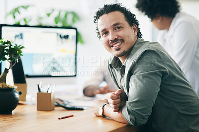 Buy stock photo Shot of a young businessman smiling in an office