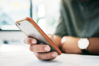 Buy stock photo Shot of an unrecognizable businessperson using a cellphone in an office
