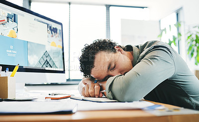 Buy stock photo Shot of a young businessman taking a nap in an office