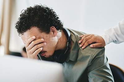 Buy stock photo Shot of a young businessman covering his eyes in an office