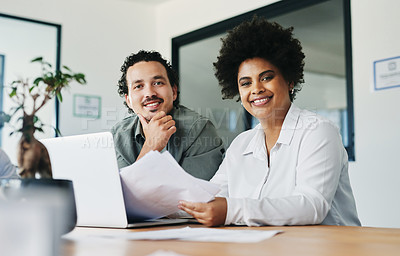 Buy stock photo Shot of two young businesspeople working in an office