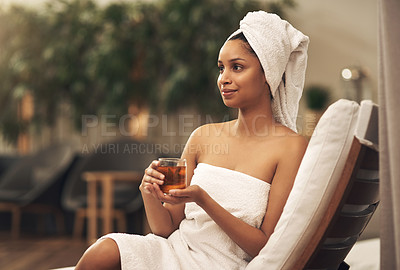 Buy stock photo Shot of a woman drinking tea while enjoying a spa day