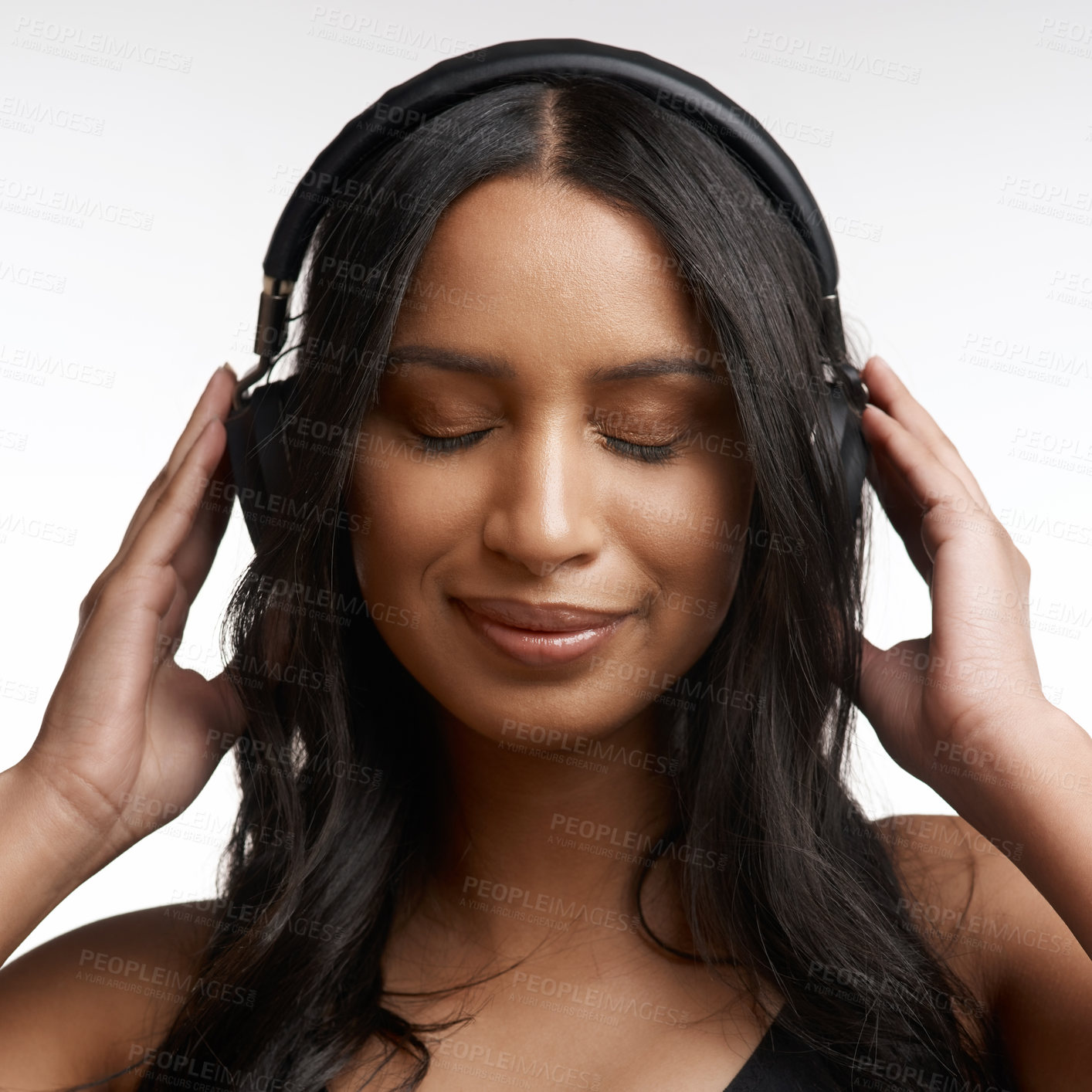 Buy stock photo Studio shot of a sporty young woman listening to music against a white background