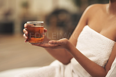 Buy stock photo Cropped shot of a woman drinking tea while relaxing at a spa