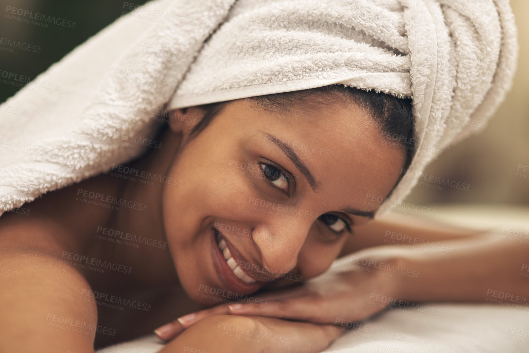 Buy stock photo Shot of a young woman smiling while lying on a massage bed at a spa