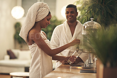 Buy stock photo Shot of a couple getting water from a dispenser in a spa