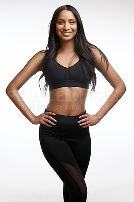 Buy stock photo Studio portrait of a sporty young woman posing against a white background