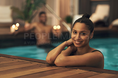 Buy stock photo Shot of a young woman relaxing in a pool at a spa