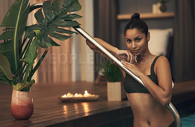 Buy stock photo Shot of a young woman relaxing in a pool at a spa