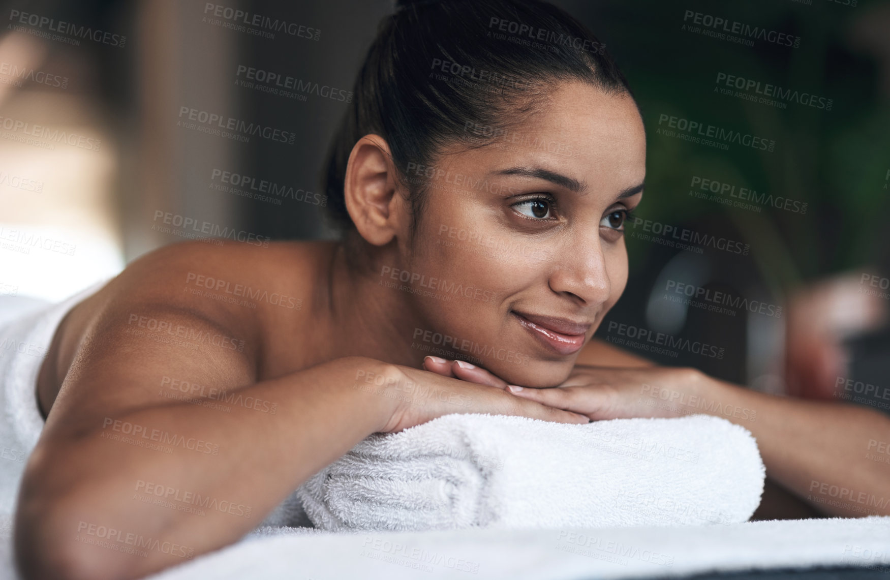 Buy stock photo Shot of a young woman lying on a massage bed at a spa