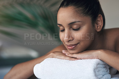 Buy stock photo Shot of a young woman lying on a massage bed at a spa