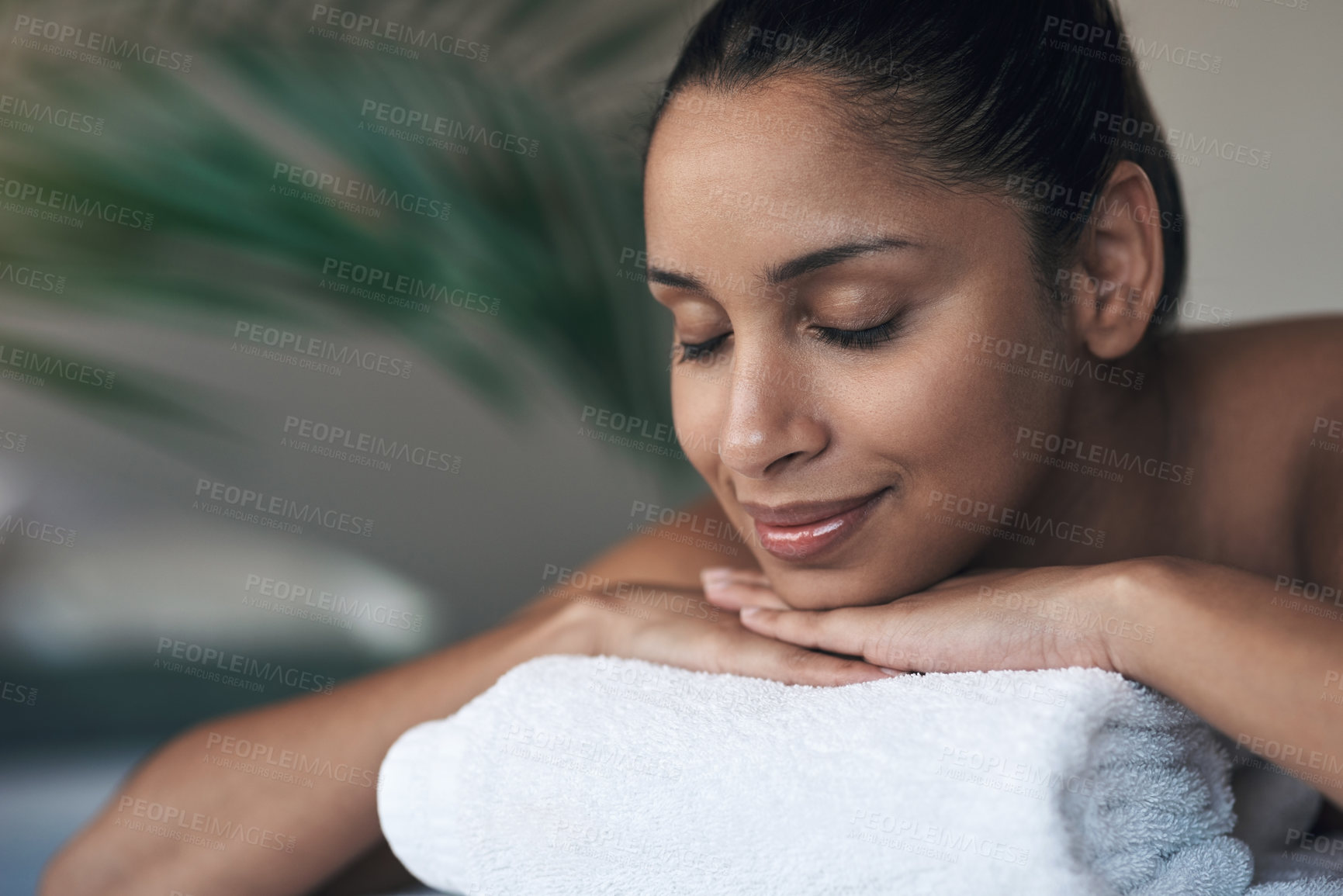 Buy stock photo Shot of a young woman lying on a massage bed at a spa