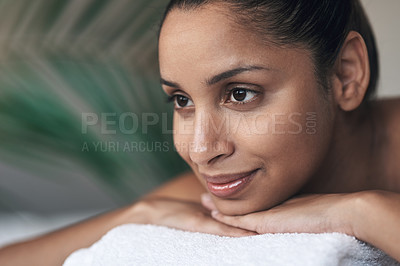 Buy stock photo Shot of a young woman lying on a massage bed at a spa