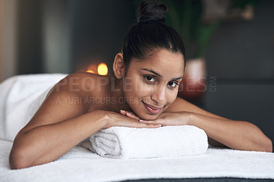 Buy stock photo Portrait of a young woman lying on a massage bed at a spa