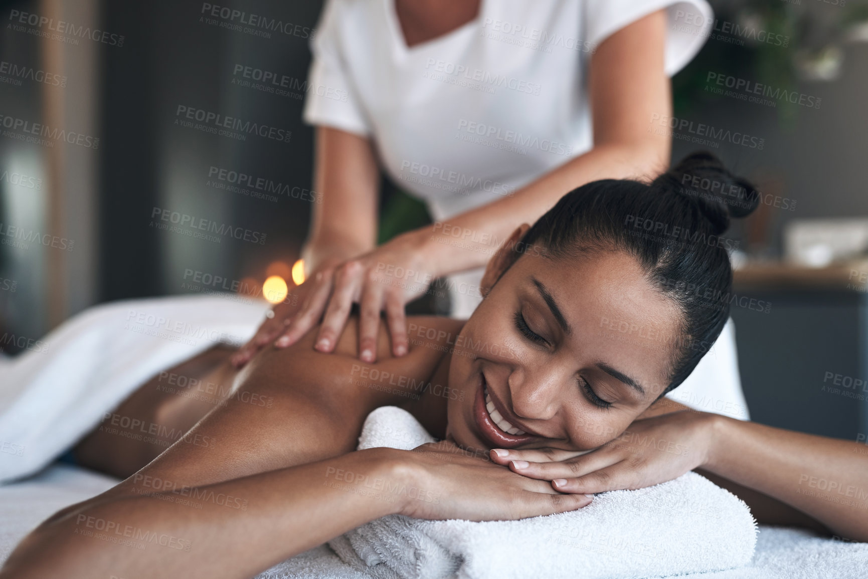 Buy stock photo Shot of a young woman getting a back massage at a spa