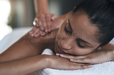 Buy stock photo Shot of a young woman getting a back massage at a spa