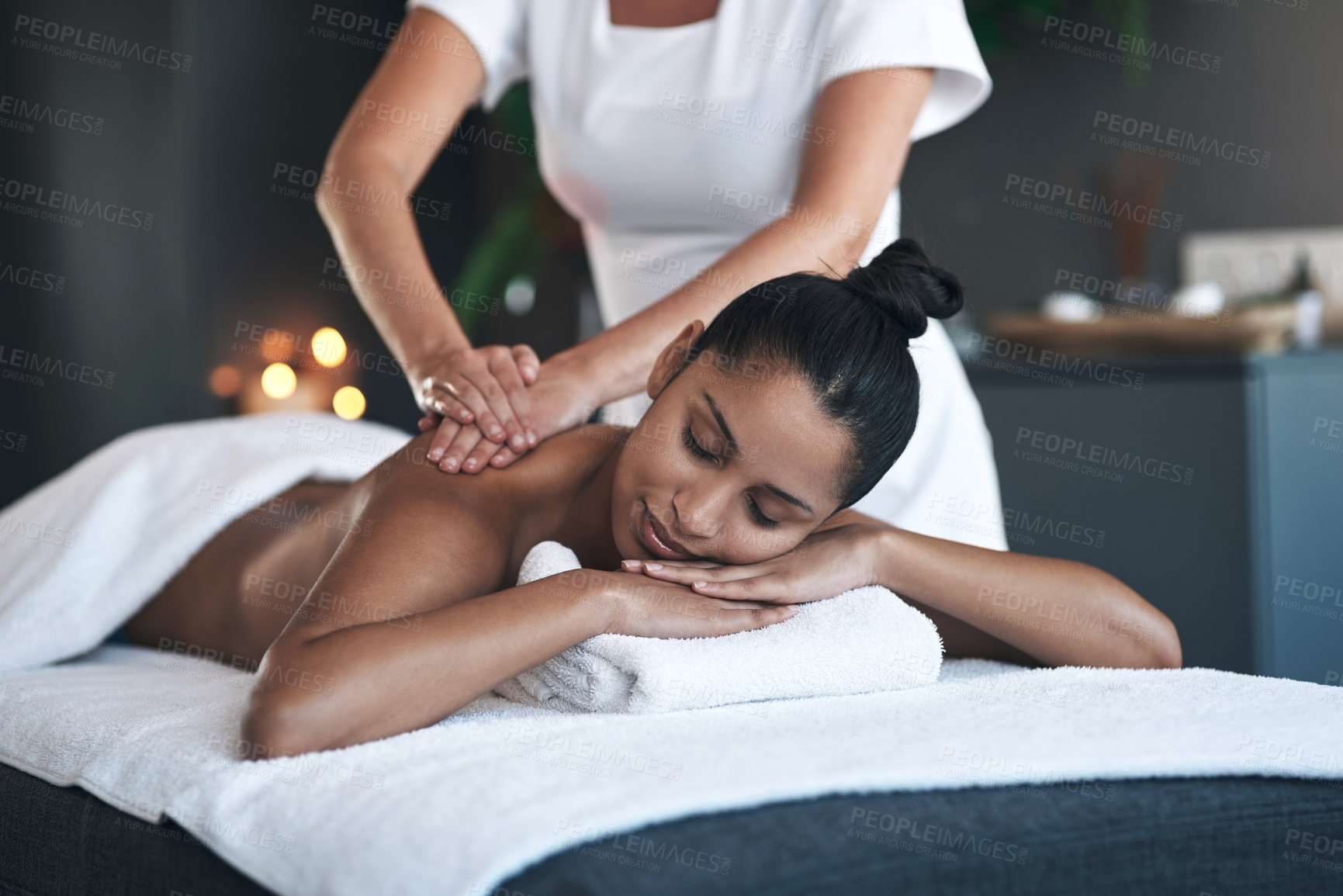 Buy stock photo Shot of a young woman getting a back massage at a spa