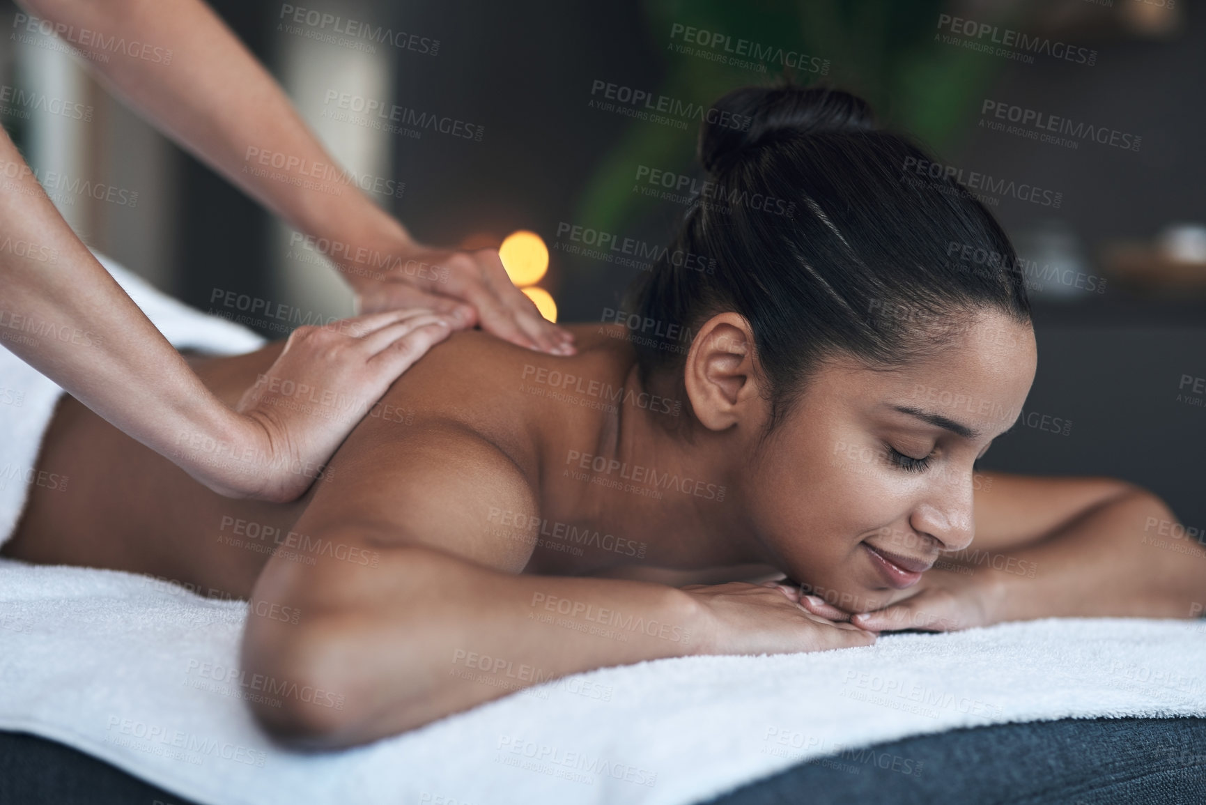 Buy stock photo Shot of a young woman getting a back massage at a spa