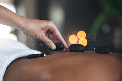 Buy stock photo Closeups shot of an unrecognisable woman getting a hot stone massage at a spa