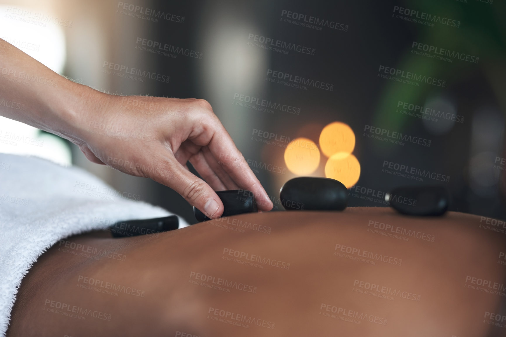 Buy stock photo Closeups shot of an unrecognisable woman getting a hot stone massage at a spa