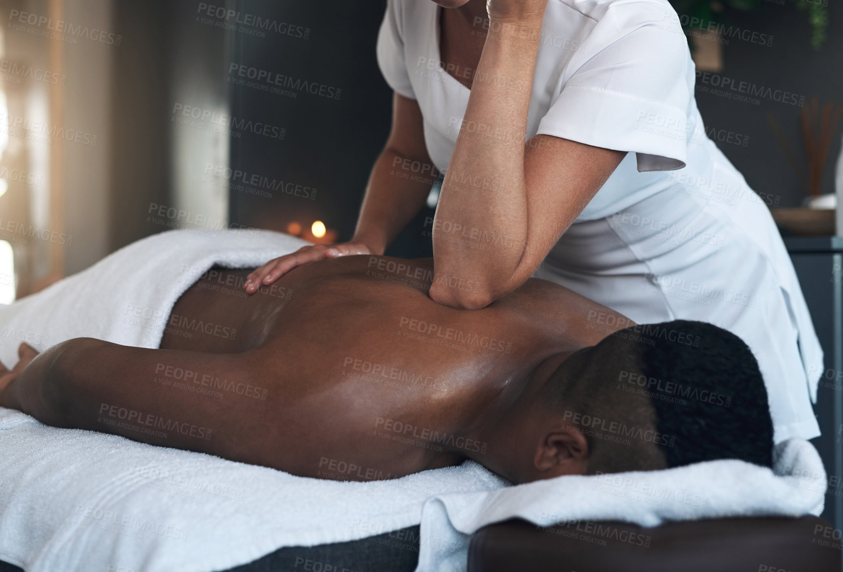 Buy stock photo Shot of a young man getting a back massage at a spa