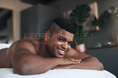 Buy stock photo Portrait of a young man lying on a massage bed at a spa