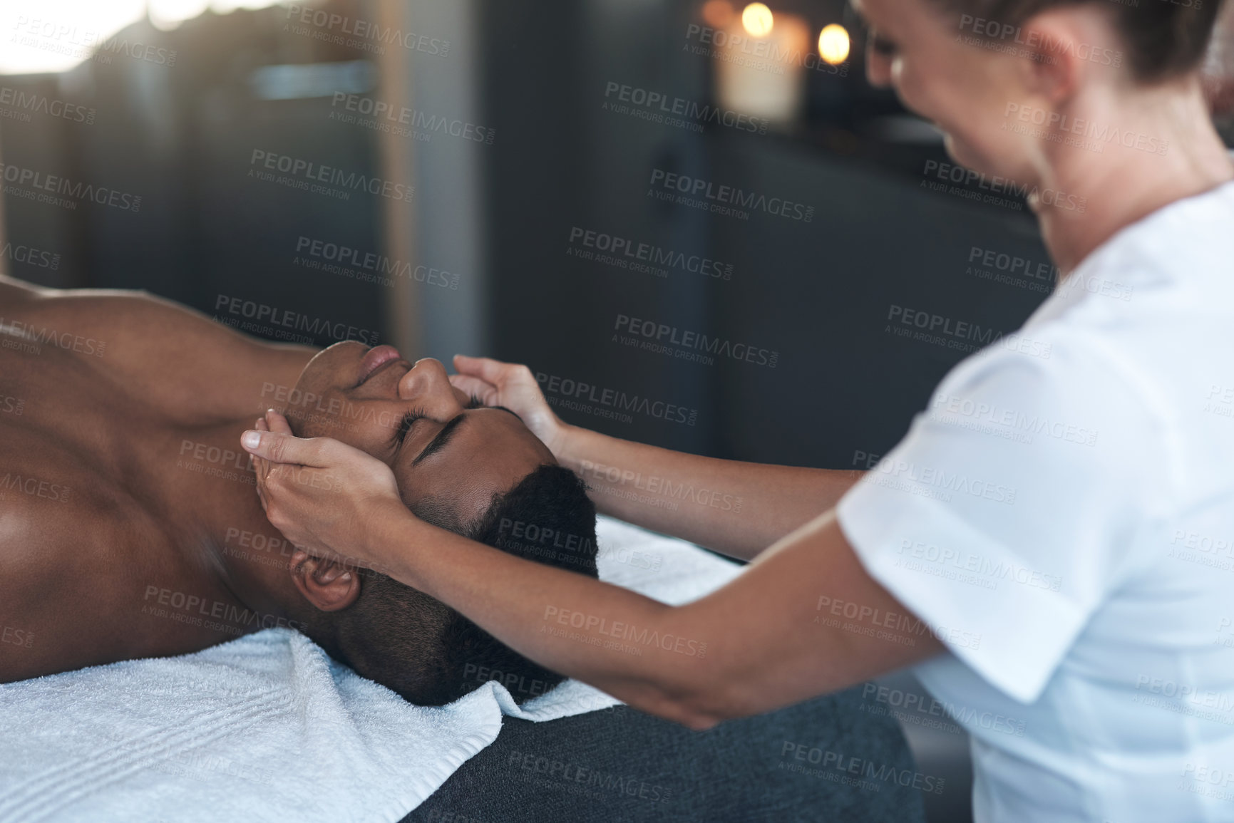 Buy stock photo Shot of a young man getting a face massage at a spa