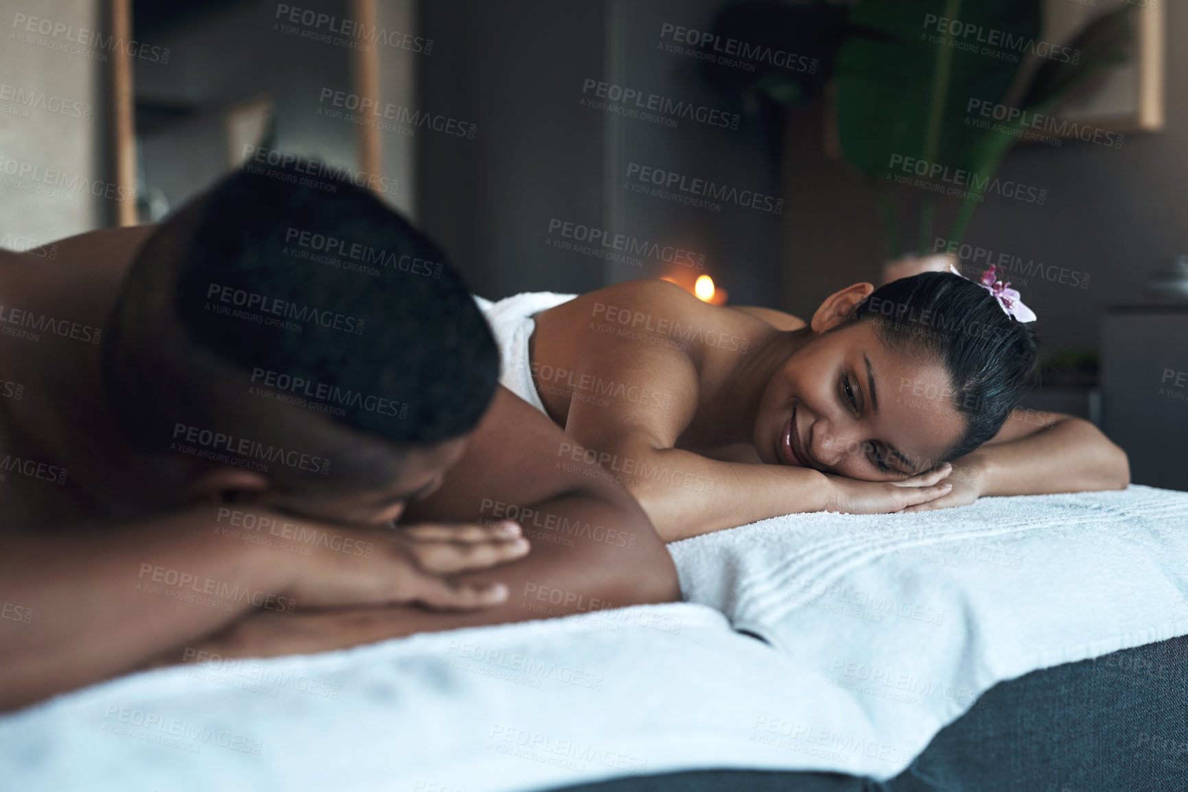Buy stock photo Shot of a young couple relaxing on massage beds at a spa