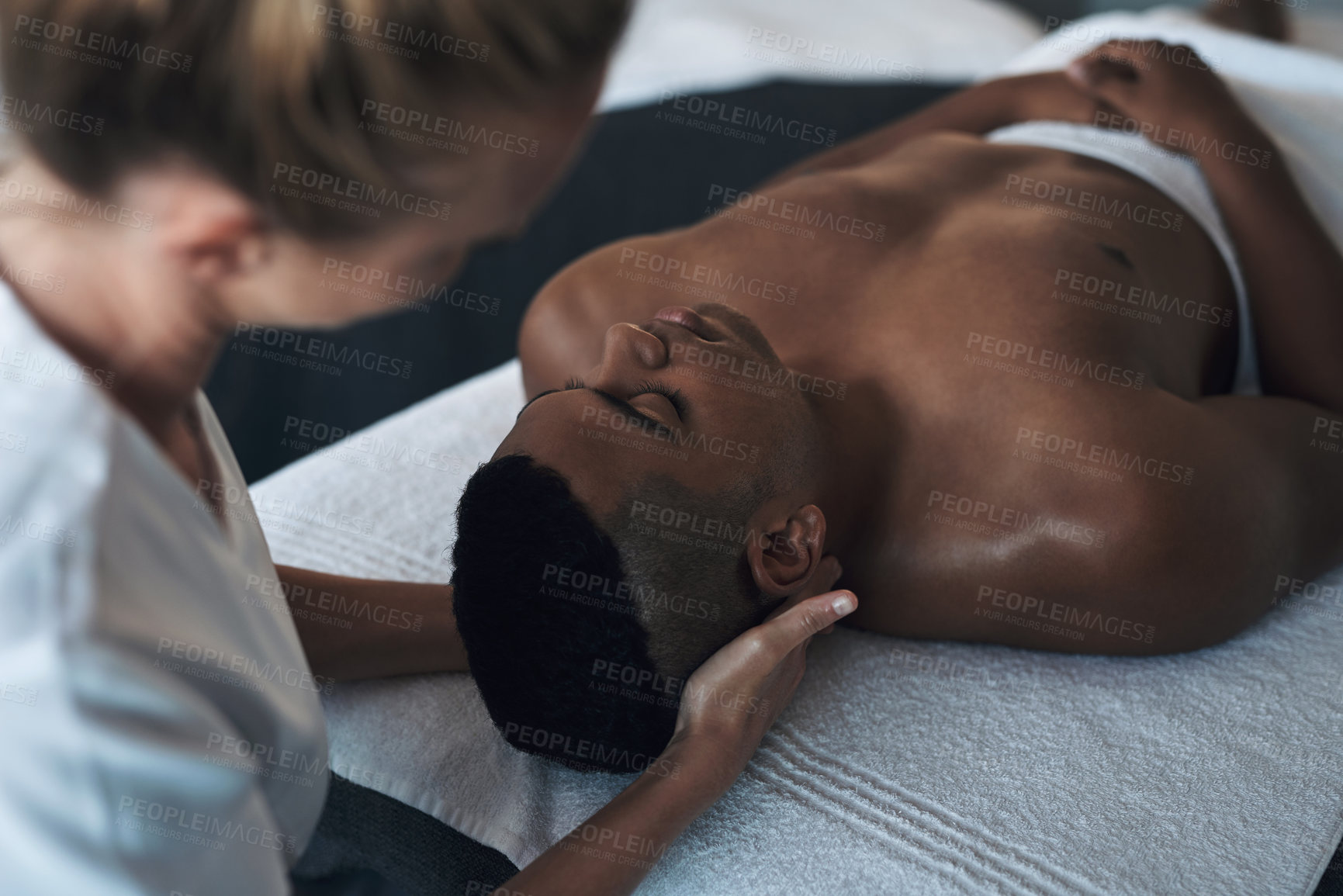 Buy stock photo Shot of a young man getting a face massage at a spa