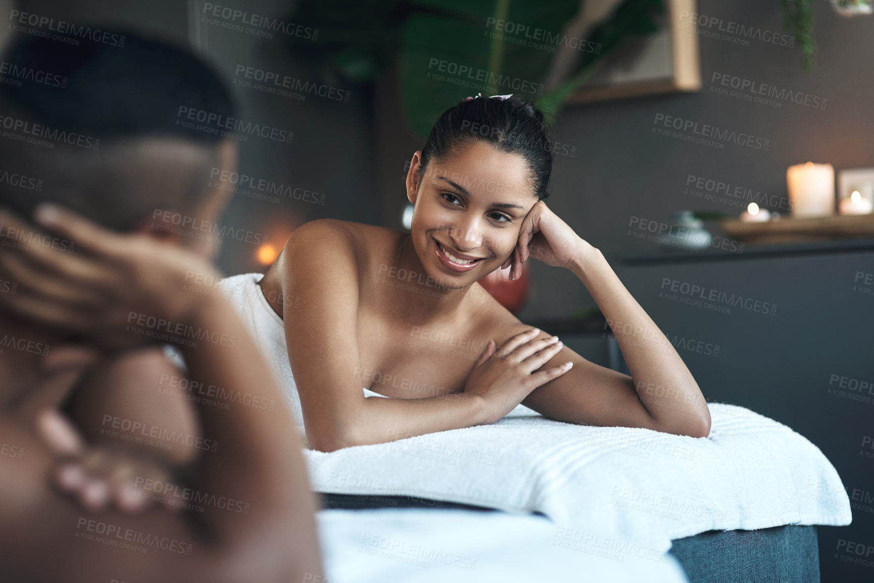Buy stock photo Shot of a young couple relaxing on massage beds at a spa