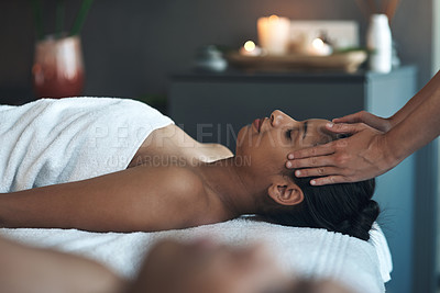 Buy stock photo Shot of a young woman getting a head massage at a spa