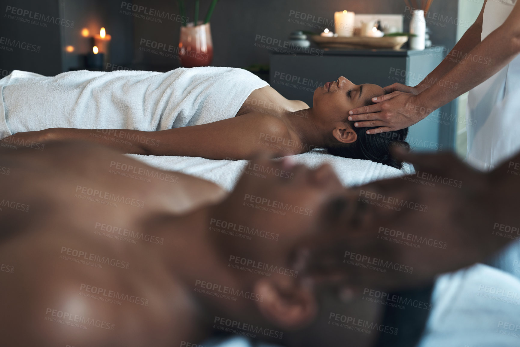Buy stock photo Shot of a young couple getting head massages at a spa